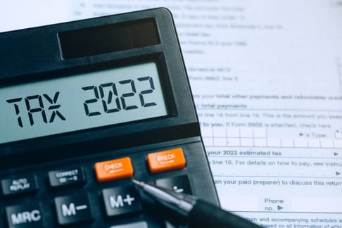 word tax 2022 on calculator on documents. income statement. pay tax rate. taxation, tax burden. business and tax concept. - tax 2022 photos and collection images